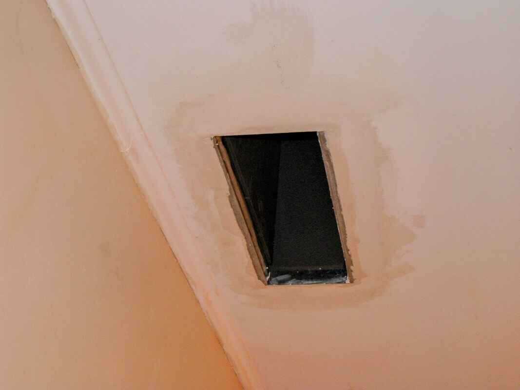 Finition au plâtre de la bouche de chauffage